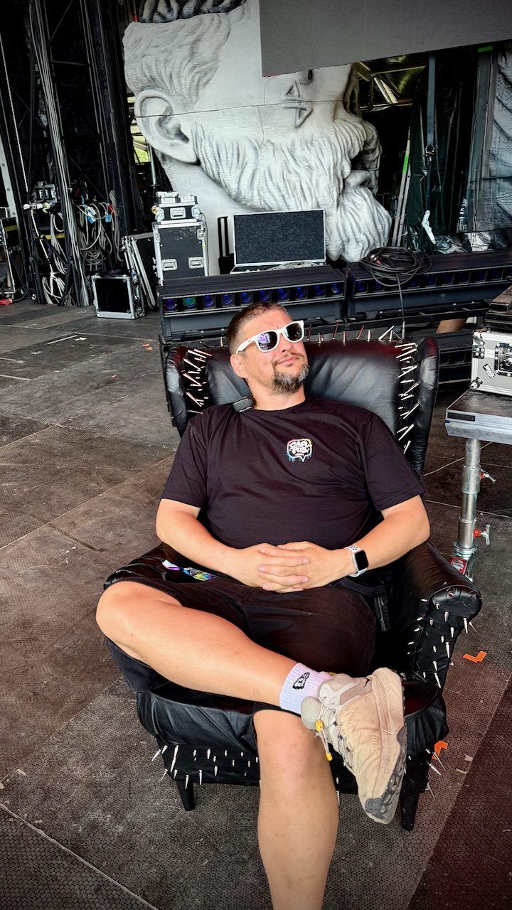 Relaxing backstage in a spiked leather armchair