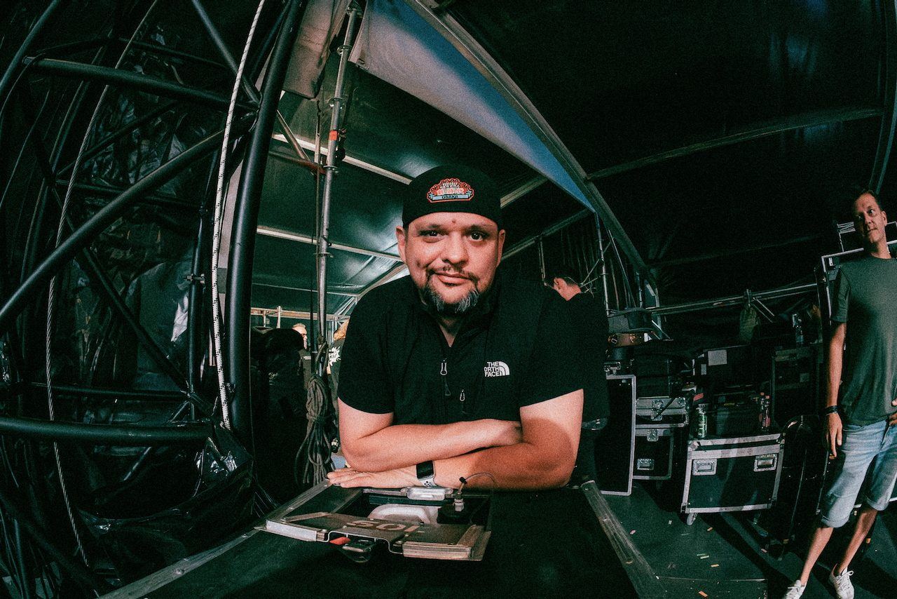 Backstage portrait in a tent full of road cases