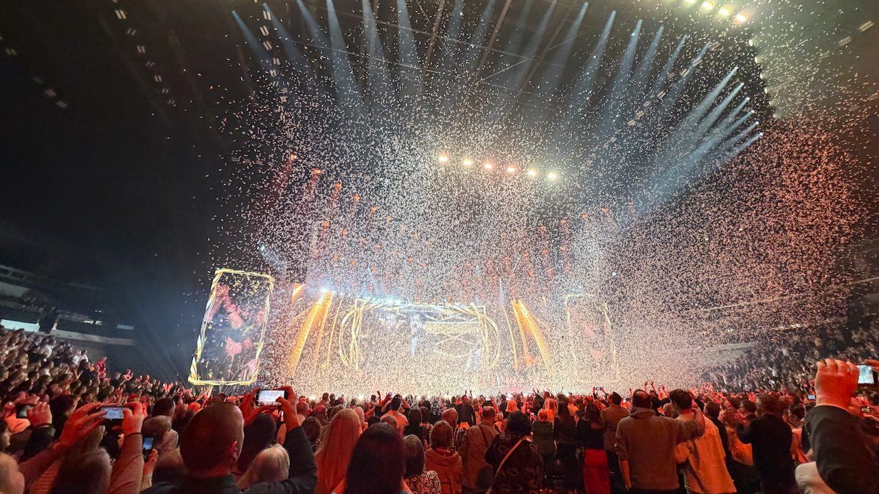 Confetti falling over an arena crowd